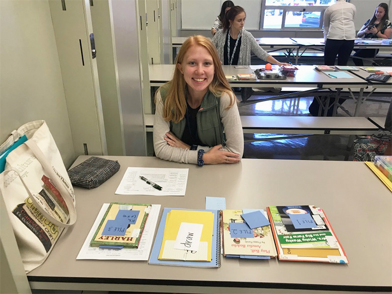 Abigail Jones sitting at a table and smiling