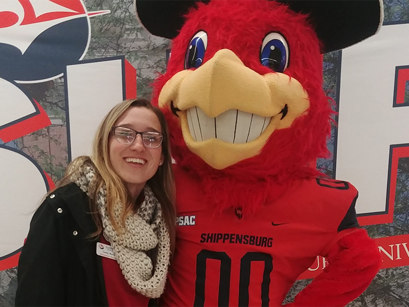 Casey Norton posing with Shippensburg University mascot Big Red