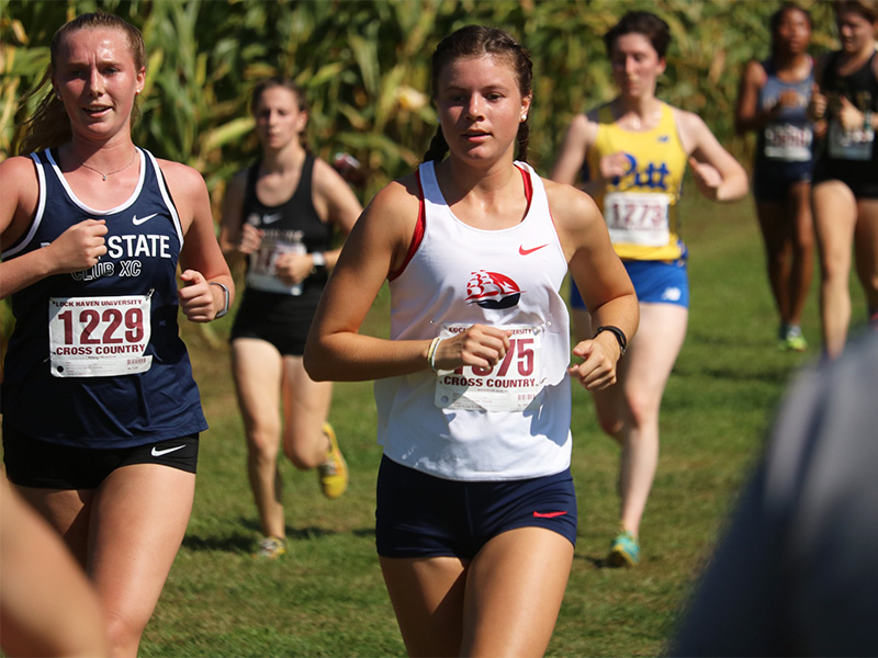 Katie Booth in a field of other cross country runners