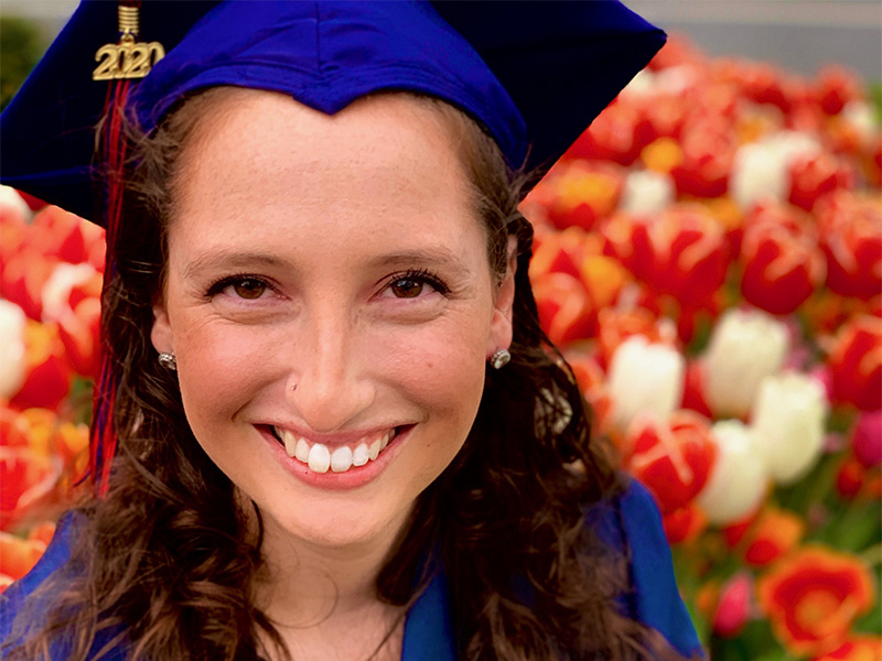 Anna D'Orazio smiling in graduation cap and gown