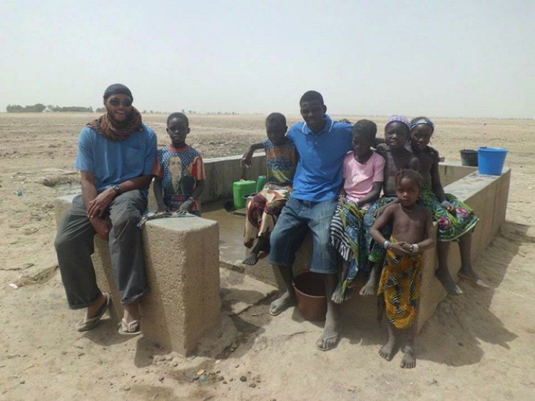 Emmanuel Ekekwe with kids getting water at a pump outside of Djenne, Mali