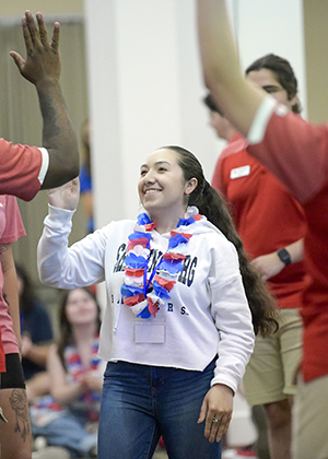 decorative - female student giving high five to another student