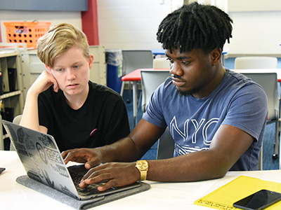 Two students with laptop
