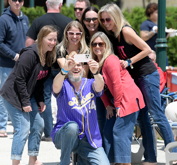 photo of man taking selfie with women