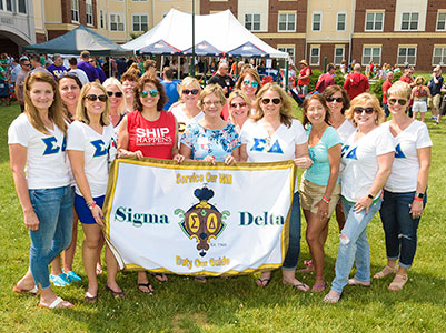 Alumni sorority  sisters with banner