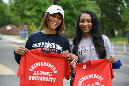 Students holding t-shirts