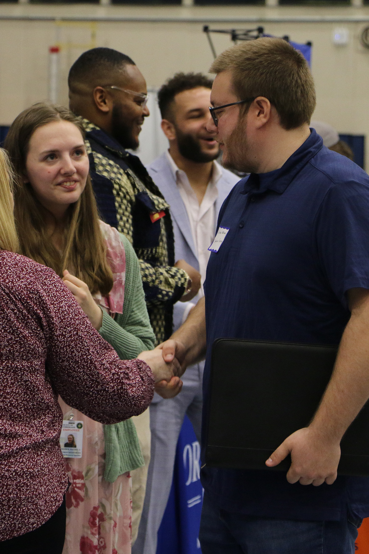 Spring 2024 career fair students shaking hands with prospective employers