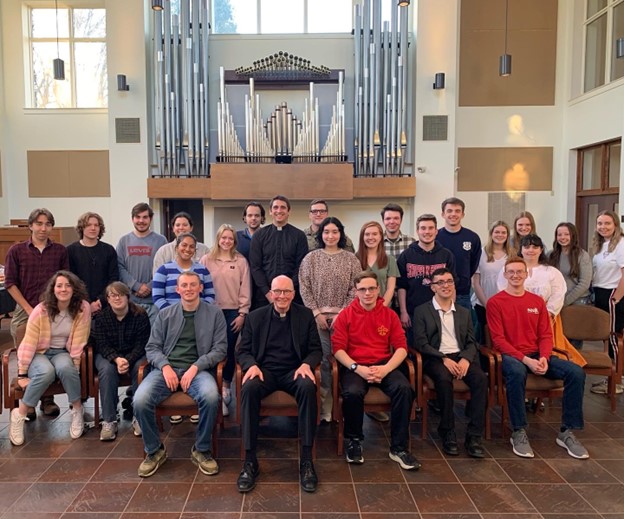 group photo of catholic priest and students
