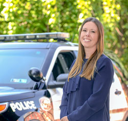 Woman standing in front of a police car