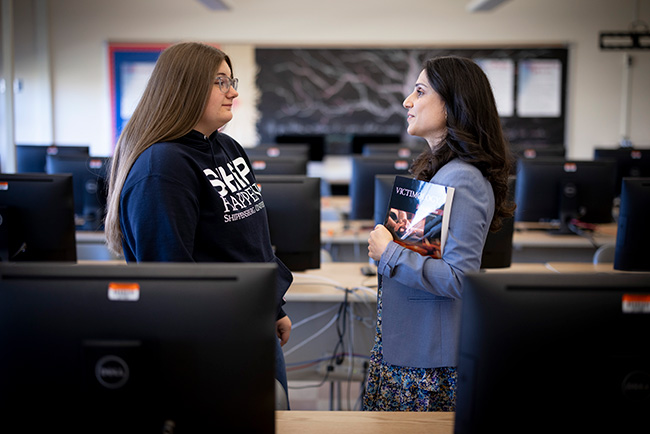 Ship student standing and talking to a mentor