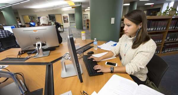 Girl at computer in the library 